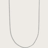 Simple silver chain necklace displayed on a light beige background.