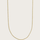 Simple gold chain necklace displayed on a light beige background.