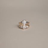 Product focus on the KARAAT Emerald Trilogy in 18k yellow gold, showcasing the clear step-cut lab-grown diamonds.