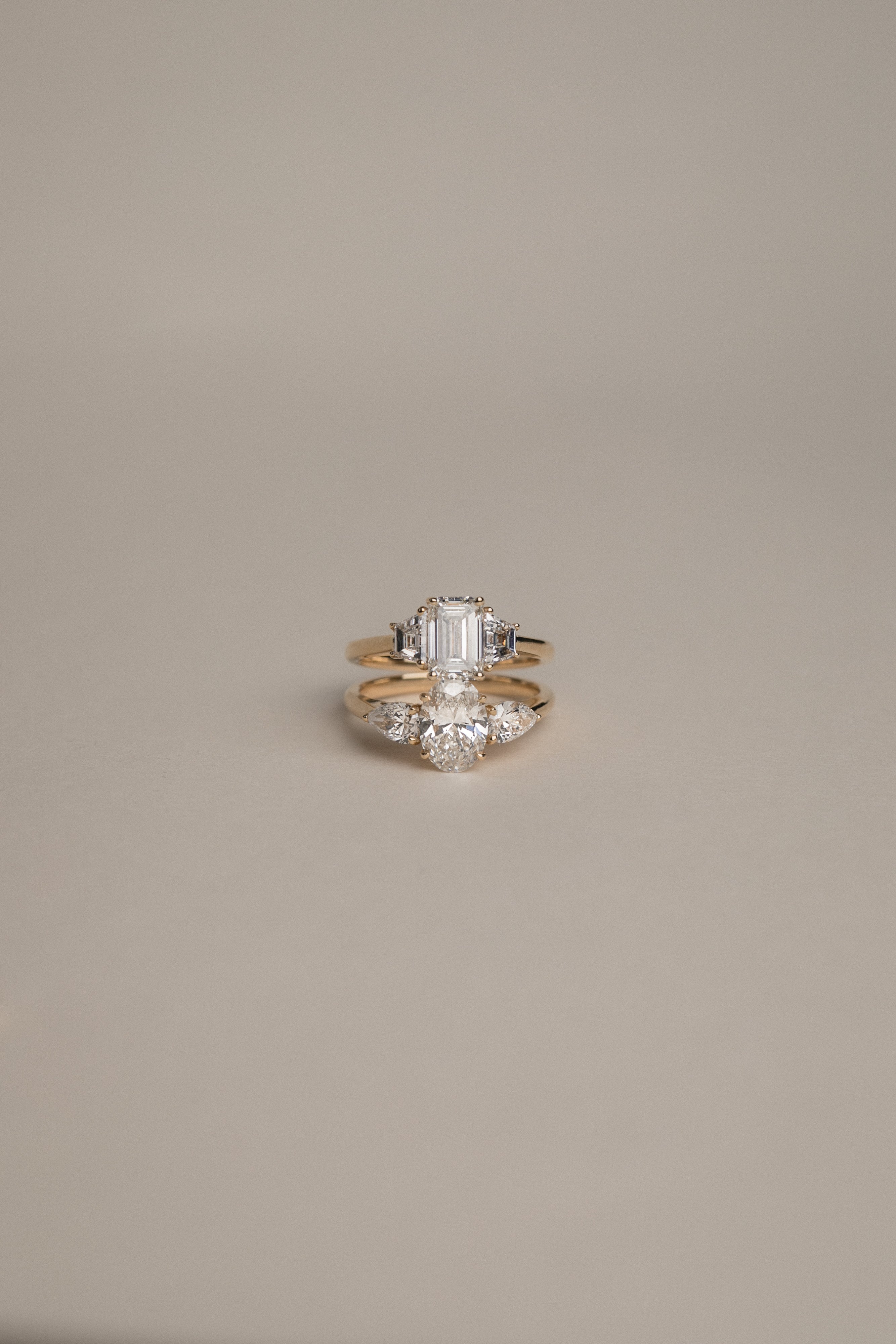 Product focus on the KARAAT Emerald Trilogy in 18k rose gold, showcasing the clear step-cut lab-grown diamonds.