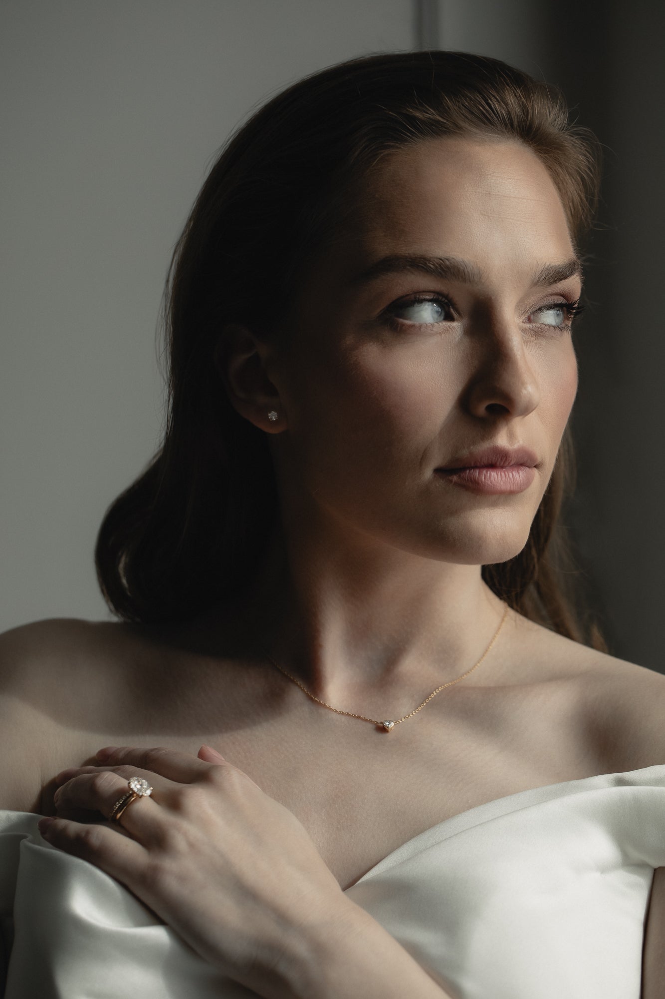 Elegant bridal jewelry by KARAAT featuring a lab-grown diamond engagement ring Oval Solitaire in 18k yellow gold and matching wedding band, styled for a modern wedding look.