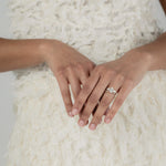 A KARAAT Oval Trilogy diamond ring in 18k yellow gold, providing elegant bridal inspiration for a modern wedding.