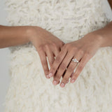 A KARAAT Oval Trilogy diamond ring in 18k yellow gold, providing elegant bridal inspiration for a modern wedding.