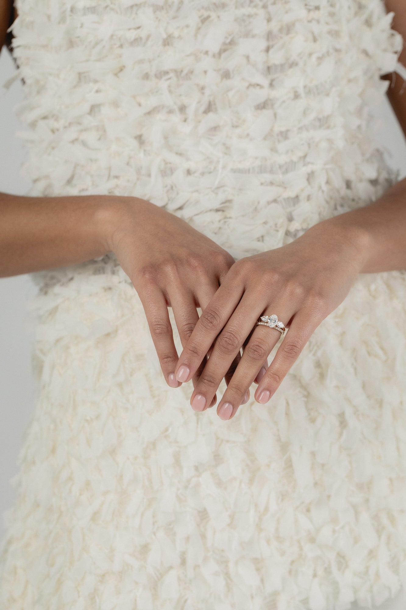 A KARAAT Oval Trilogy diamond ring in 18k yellow gold, providing elegant bridal inspiration for a modern wedding.