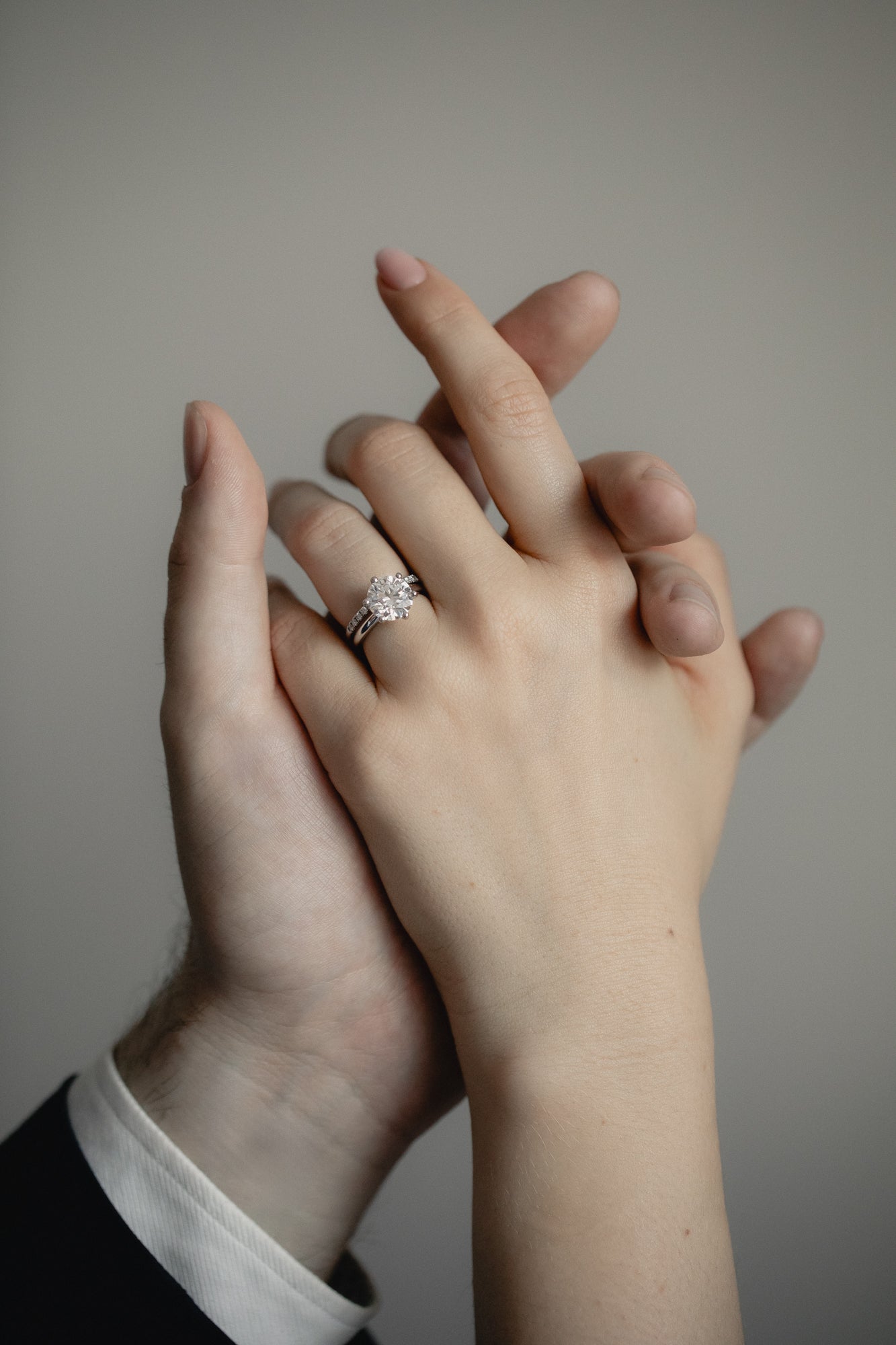 An intimate couple’s moment featuring the KARAAT Round Six Prong Solitaire engagement ring in 18k white gold.