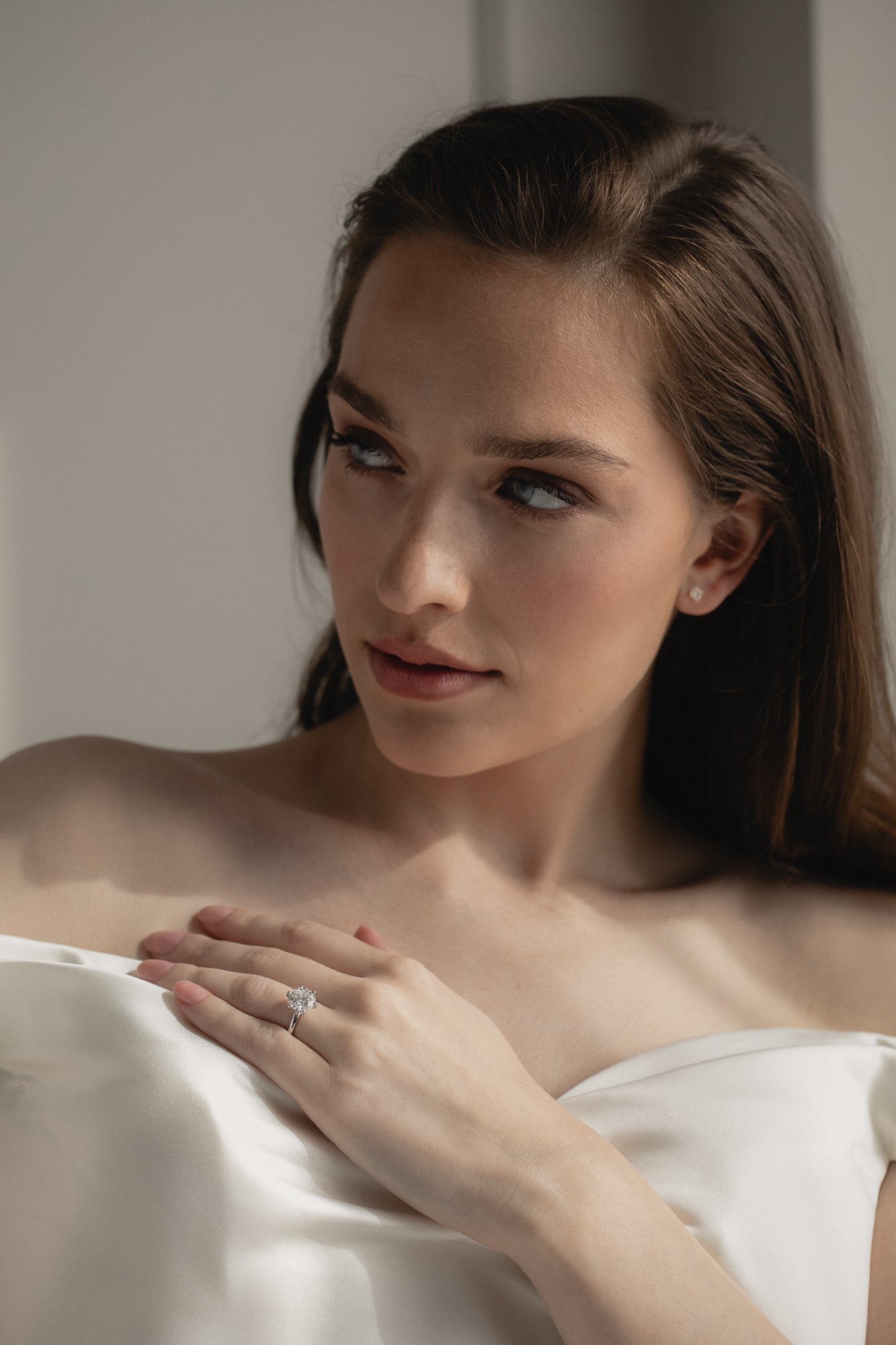 A bride wearing the KARAAT Round Six Prong Solitaire ring in 18k yellow gold, styled with a modern wedding look.