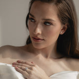 A bride wearing the KARAAT Round Six Prong Solitaire ring in 18k rose gold, styled with a modern wedding look.
