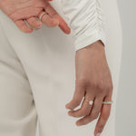 Model wearing the KARAAT Round Solitaire in 18k yellow gold, highlighting the brilliance of the lab-grown diamond on hand.