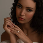 Romantic bridal styling with the KARAAT Round Trilogy three-stone diamond ring in 18k yellow gold.