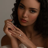 Romantic bridal styling with the KARAAT Round Trilogy three-stone diamond ring in 18k yellow gold.