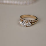Detailed close-up of the KARAAT Round Trilogy diamond ring in 18k white gold, showing the three-stone setting.
