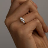 The KARAAT Round Trilogy engagement ring in 18k yellow gold shown on a model, highlighting its brilliant sparkle.