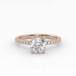 Classic cushion shaped solitaire diamond ring with a rose gold band featuring pavé diamonds.