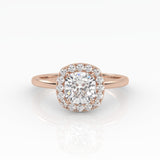 A dazzling cushion-cut diamond nestled on a sparkly halo setting and sophisticated rose gold band.