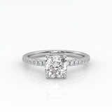 Elegant Cushion Solitaire Engagement Ring with sparkling pavé band shown in white gold.